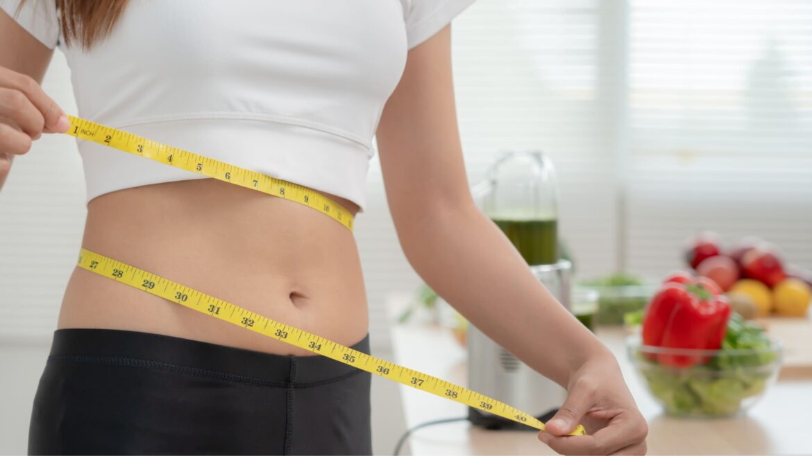 woman measuring her waist
